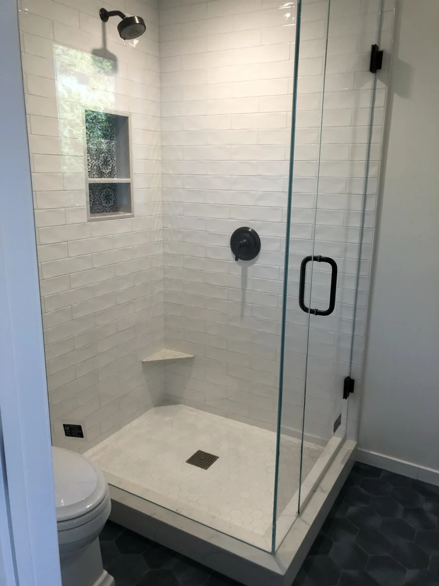 White subway tile shower with custom decorative floor — SB Tile Pro, Santa Barbara